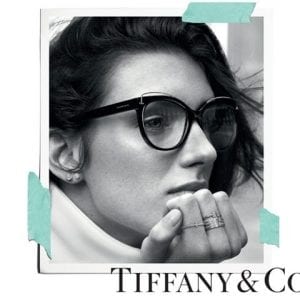 A woman wearing Tiffany and co glasses and rings