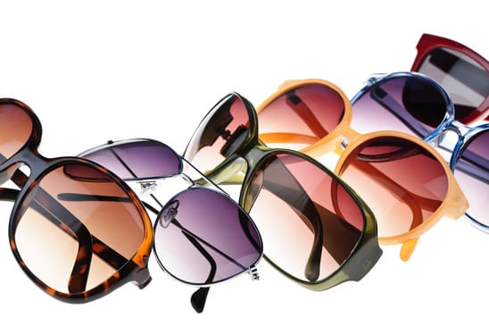 Different styles of tinted sunglasses on white background