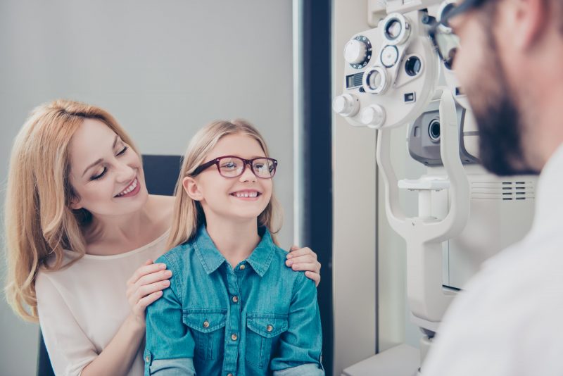 A young girl getting an eye exam from the vision gallery